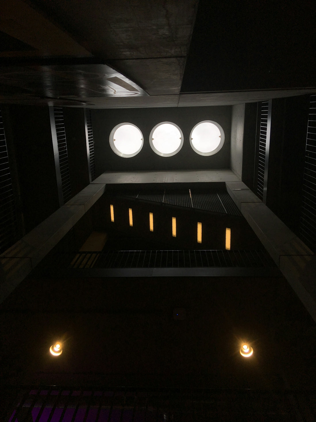 a dimly lit room with three round lights