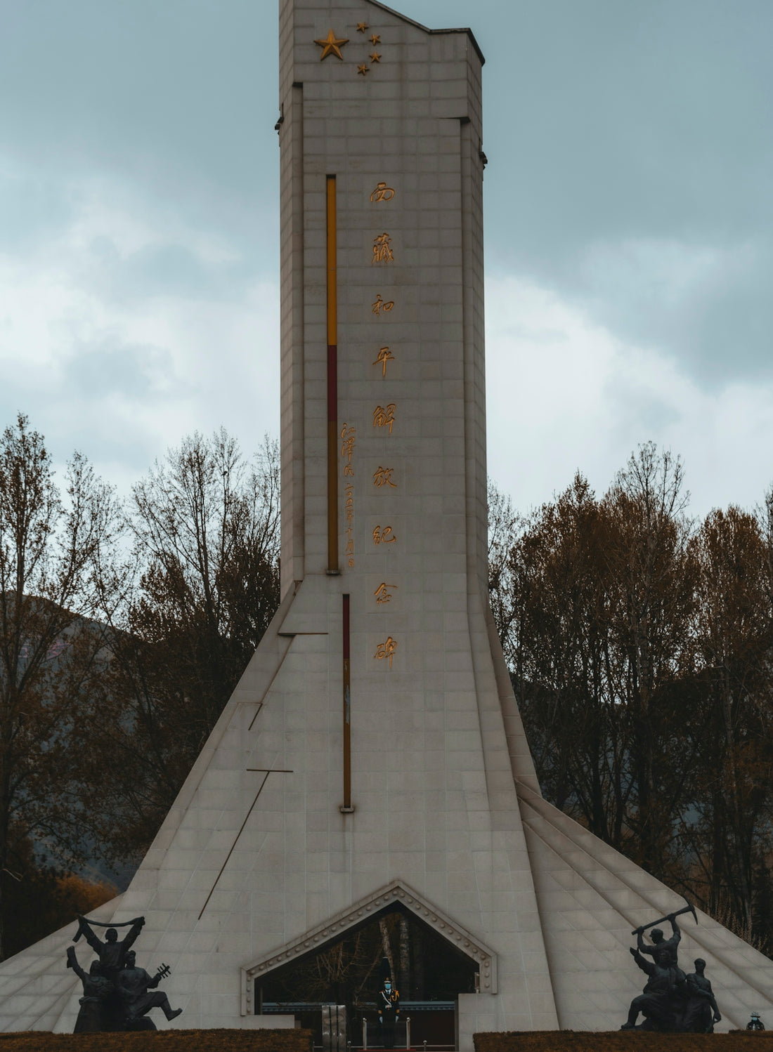a tall white building with a clock on it's side