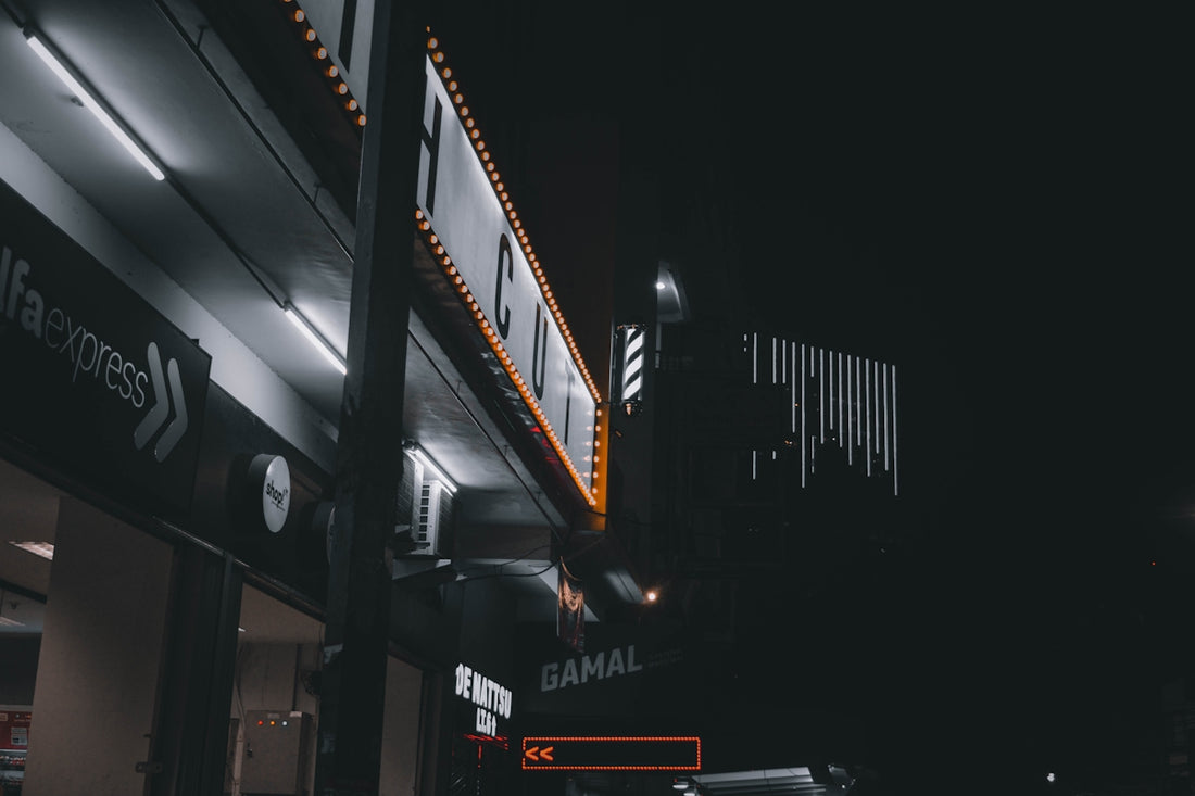 a dark street at night with a building lit up